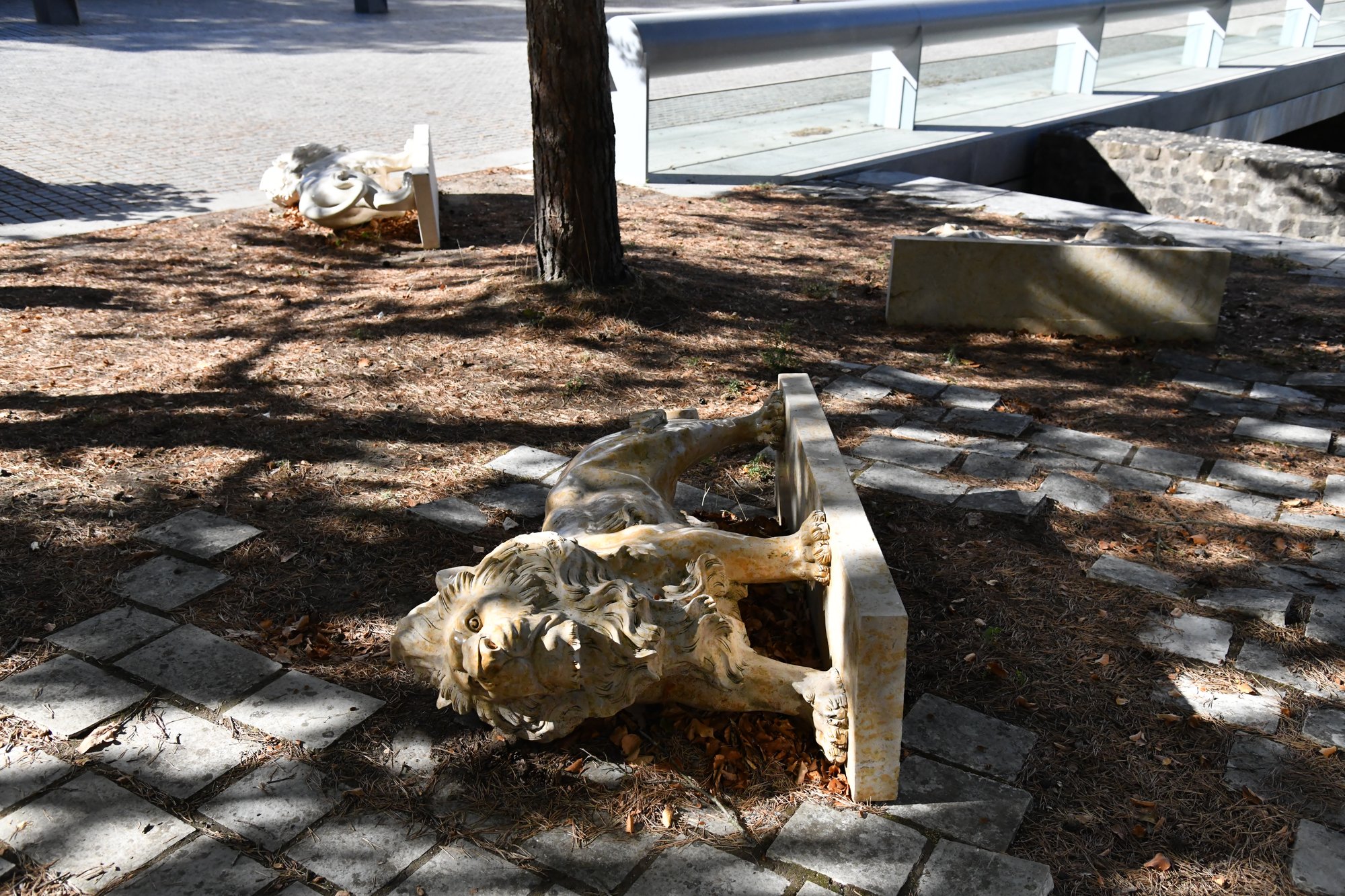 a stone sculpture in a sandy courtyard
